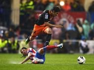 Atletico Madrid's Filipe Luis (down) vies with Valencia's Tino Costa in Madrid on March 31, 2013